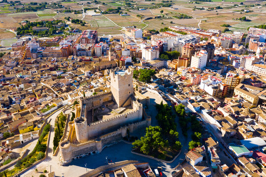 Scenic view from drone of houses and old Castle de Atalaya of Villena town at sunny day, Spain