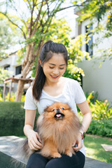 Asian woman and pomeranian spitz dog.