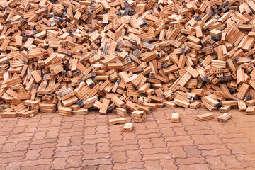 Pile of bricks on old brown floor background in construction site background
