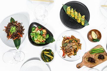 Asian food served on white table. Chinese and vietnamese cuisine set.  Gray background. Top view