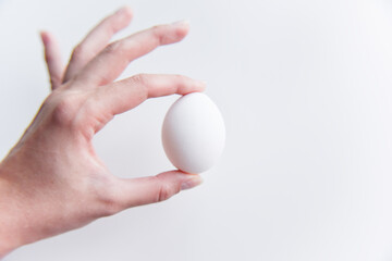 Fototapeta na wymiar selective focus at the white egg in the hand
