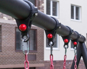 attaching chains to the crossbar on the swings