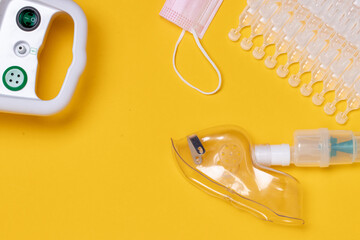 Coronavirus protective measures. Closeup of a inhaler device with medical face mask or nebulizer...