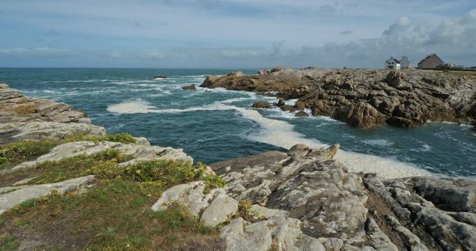 Penmarch, Finistere department, Brittany, France. Pointe of Penmarch with the famous rocks. Pointe of Penmarch with the famous rocks..On the foreground are wild flowers named rock samphire.