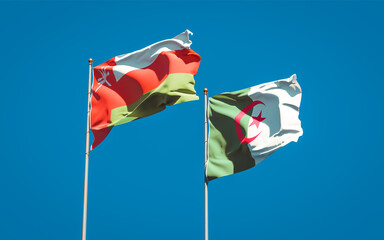 Beautiful national state flags of Oman and Algeria together at the sky background. 3D artwork concept.