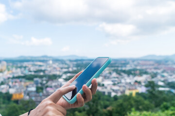 Woman hand using smartphone to do work business, social network, communication with city view.