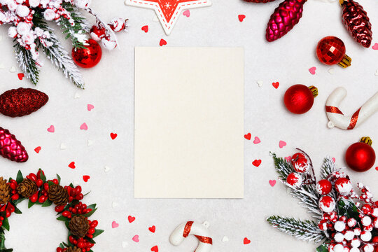 Christmas greeting card with fir tree branches, decorations balls on  white marble background. Composition with copy space for text. Flat lay, top view