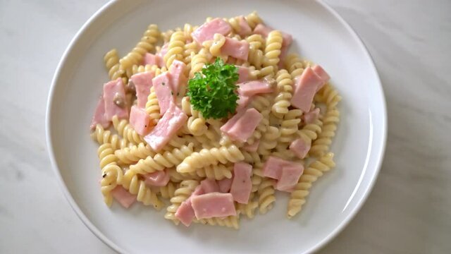 spirali or spiral pasta mushroom cream sauce with ham - Italian food style