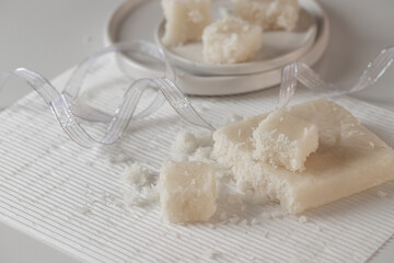 Artisan Coconut Nougat or Turron de coco  on white background with Christmas decoration.