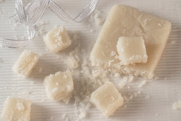 Artisan Coconut Nougat or Turron de coco  on white background with Christmas decoration.