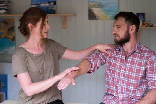 Alternative therapist and man during a consultation, using EFT tapping techniques therapy 