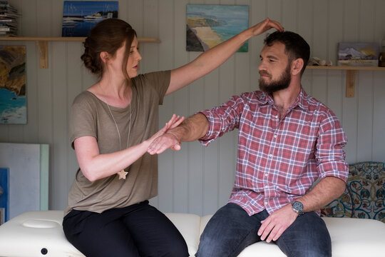 Alternative therapist and man during a consultation, using EFT tapping techniques therapy 