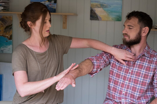 Alternative therapist and man during a consultation, using EFT tapping techniques therapy 