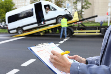 Female agent fills out an insurance policy after car accident. Procedure for an insured event...