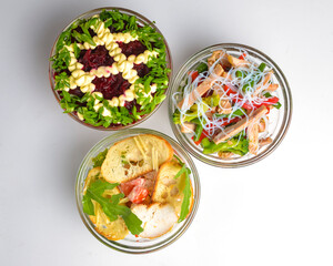 Healthy food - mix vegetable salad served in a bowl over white background. Healthy eating, delicious snack or dinner.