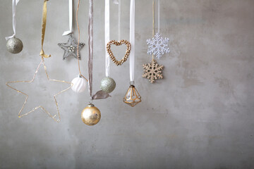 Christmas decorations, close up of silver, white and golden Christmas baubles on ribbons