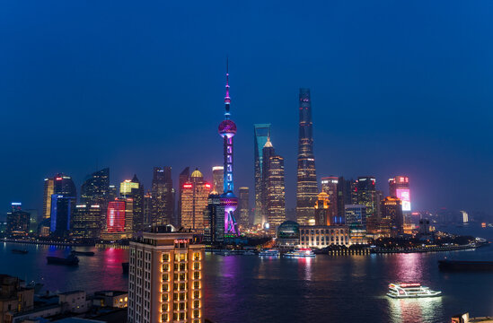 Skyline of the Pudong Financial district across Huangpu River at dusk, Shanghai, China.