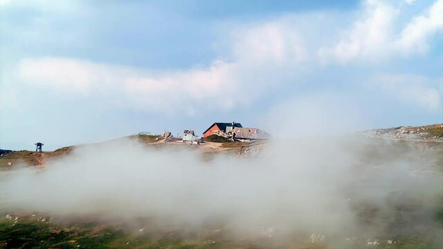 Challet on top of the mountain surrounded by fog, seamless loop.mov