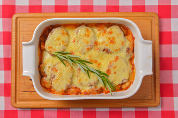Zucchini baked with cheese in a dish, close up food. Delicious meat and cheese casserole. Italian cuisine concept.
