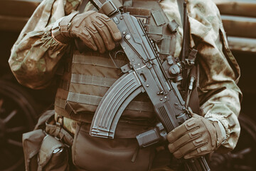 a soldier holds a weapon in his hands