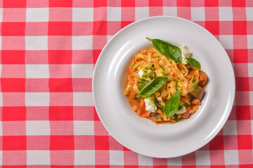 Italian penne pasta or noodles with a savory tomato sauce, fresh basil and grated parmesan cheese.
