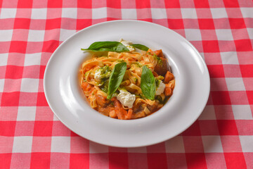 Italian penne pasta or noodles with a savory tomato sauce, fresh basil and grated parmesan cheese.