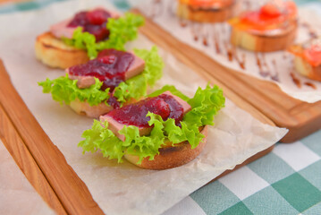 Juicy fresh Italian bruschetta over green plaid table cloth. Traditional Italian cuisine concept.