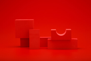 Abstract concept, monochromic still life with red geometric figures on red background