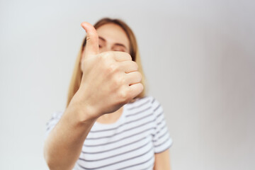 emotional woman in striped t-shirt gesture with hands lifestyle light background