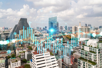 Forex and stock market chart hologram over panorama city view of Bangkok, the financial center in Asia. The concept of international trading. Double exposure.