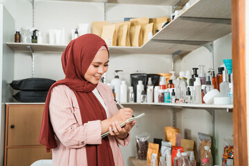 portrait of young Muslim women being notes the bottle product