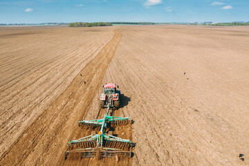 Aerial View. Tractor Plowing Field In Spring Season. Beginning Of Agricultural Spring Season....