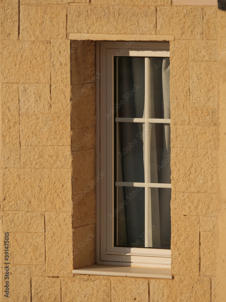 Poster vertical shot of a narrow rectangular window of a building