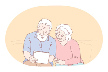 Senior elderly couple living happy active lifestyle concept. Mature aged couple grandparents cartoon characters sitting looking at photos in photo album and enjoying time and love together at home 