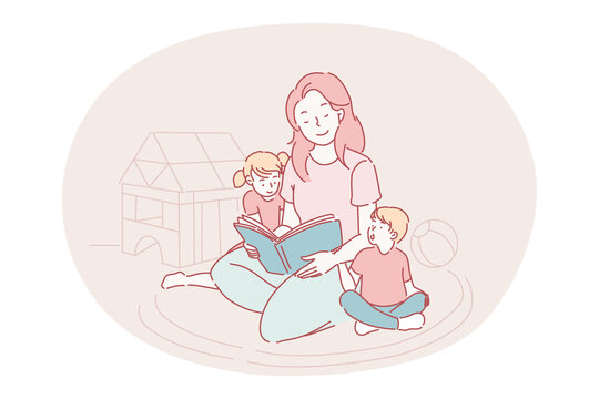 Happy leisure and activities at home with children concept. Young woman mother cartoon character sitting on carpet together with son and daughter and reading book for them at home. Relax, rest, family