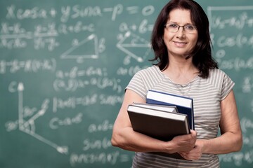 Smile woman teacher with books on background