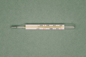 Glass mercury thermometer. Medical instrument for measuring human body temperature. Research concept for patients with covid-19 and other infections