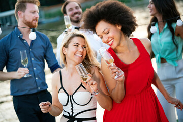 Group of friends having fun and celebrating group gathering outdoor