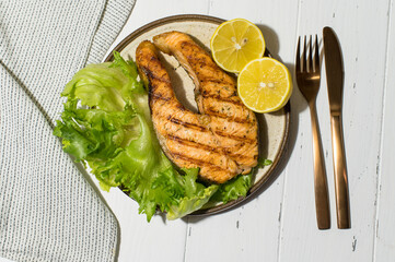 Homemade organic salmon steak with lettuce leaves