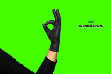 Hand ok sign. Man's hand in black rubber glove shows symbol of fine, making Gesture okay on Chroma key. Studio shot. High quality photo with space for text or logo.