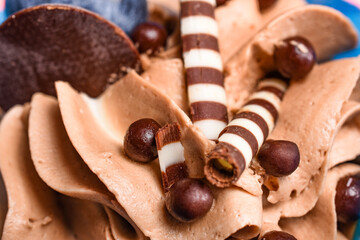 Macro chocolate dessert with chocolate balls and striped straw