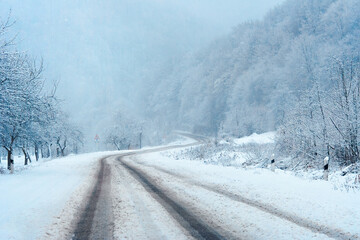 country road through mountains in winter. beautiful nature scenery. snow weather