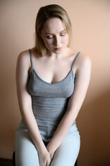 Obraz premium Graceful young woman posing against beige wall.