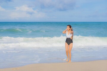 Fototapeta na wymiar Portrait beautiful young asian woman relax smile around beach sea ocean