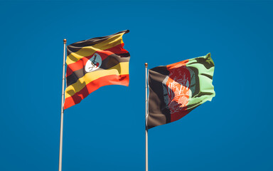 Beautiful national state flags of Uganda and Afghanistan together at the sky background. 3D artwork concept.