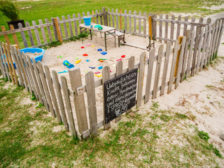 Fenced sandpit with toys