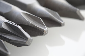 Metal heads for gray screwdriver or screwdriver closeup. Sale and rental of tools for repair concept