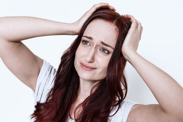Fototapeta premium Woman holds hands on her head and feels headache.