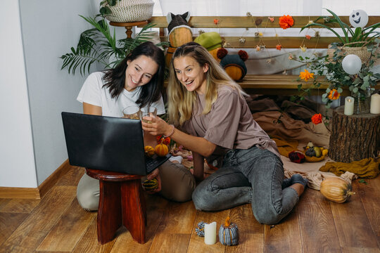 Thanksgiving Online Party, Virtual Dinner Gathering. Holidays In The Time Of COVID New Normal, Pandemic Time. Happy Family, Friends, Two Women Celebrating Thanksgiving Via Internet Near Laptop