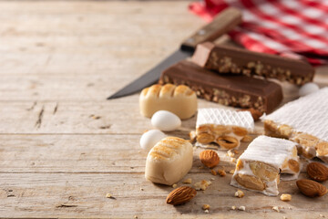 Assortment of Christmas nougat on wooden background. Copy space